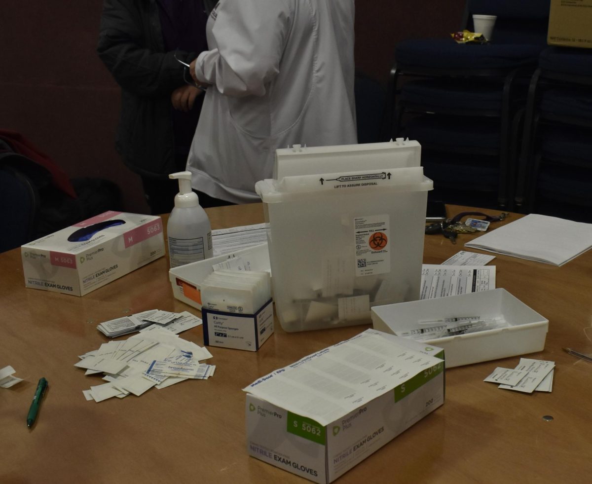A COVID-19 vaccine station stocked with syringes, gloves and alcohol swabs, ready to serve community members. 