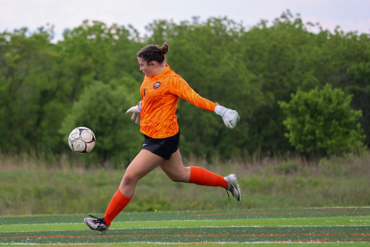 Elizabeth Lehmkuhl (1) of Ames drop kicks the ball. She finished with seven saves.
