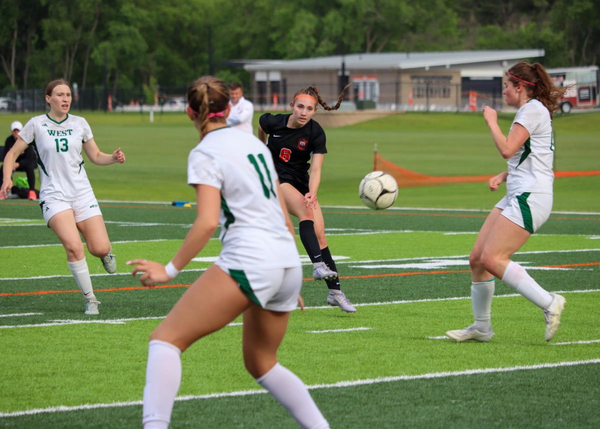 Carly Selsby, Ames’ leading goal scorer in the 2025 season, bends a shot through a trio of Trojans.
