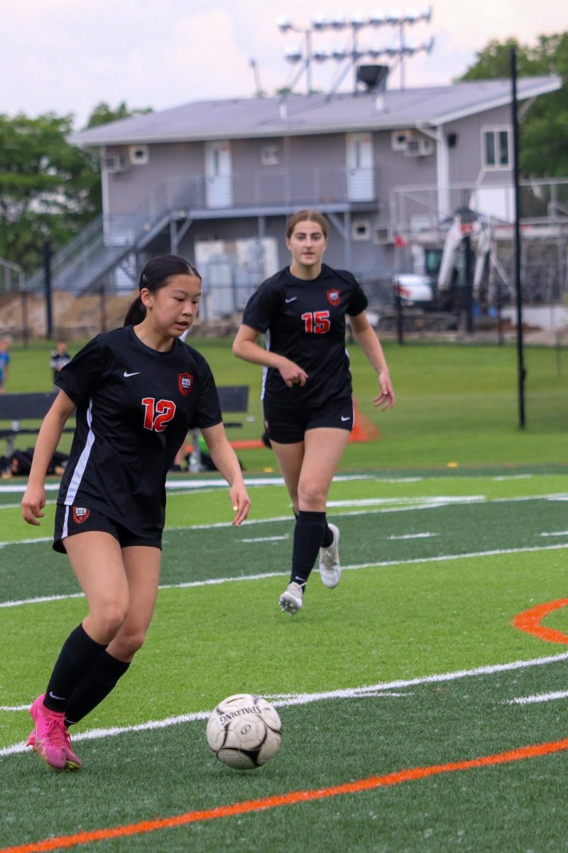 Little Cyclones Simay Zhu (12) and Sophia Kyveryga (15) push the ball upfield.