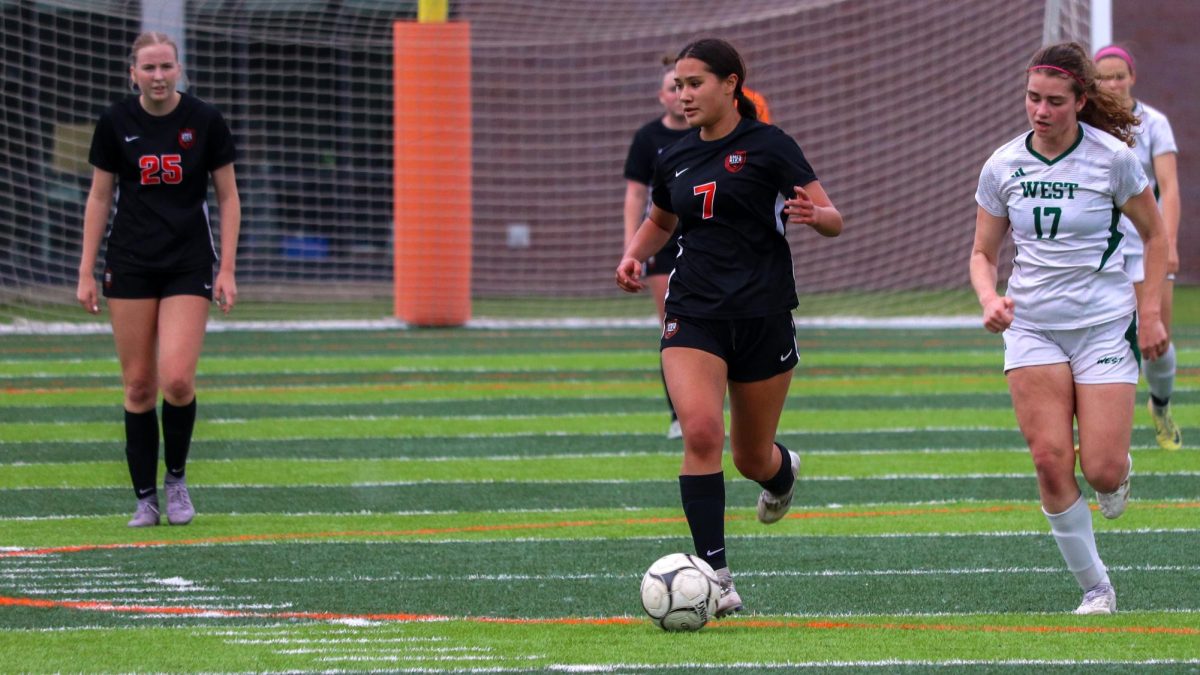 Deirbhile Hennessy (7) of Ames dribbles the ball on the Trojans’ half of the pitch.