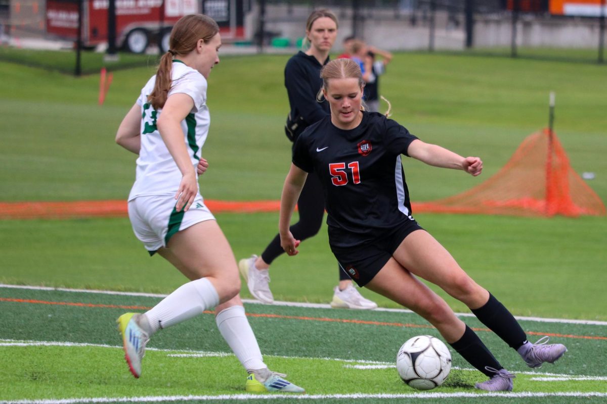 Sara Bierbaum (51) changes direction against an Iowa City West defender.