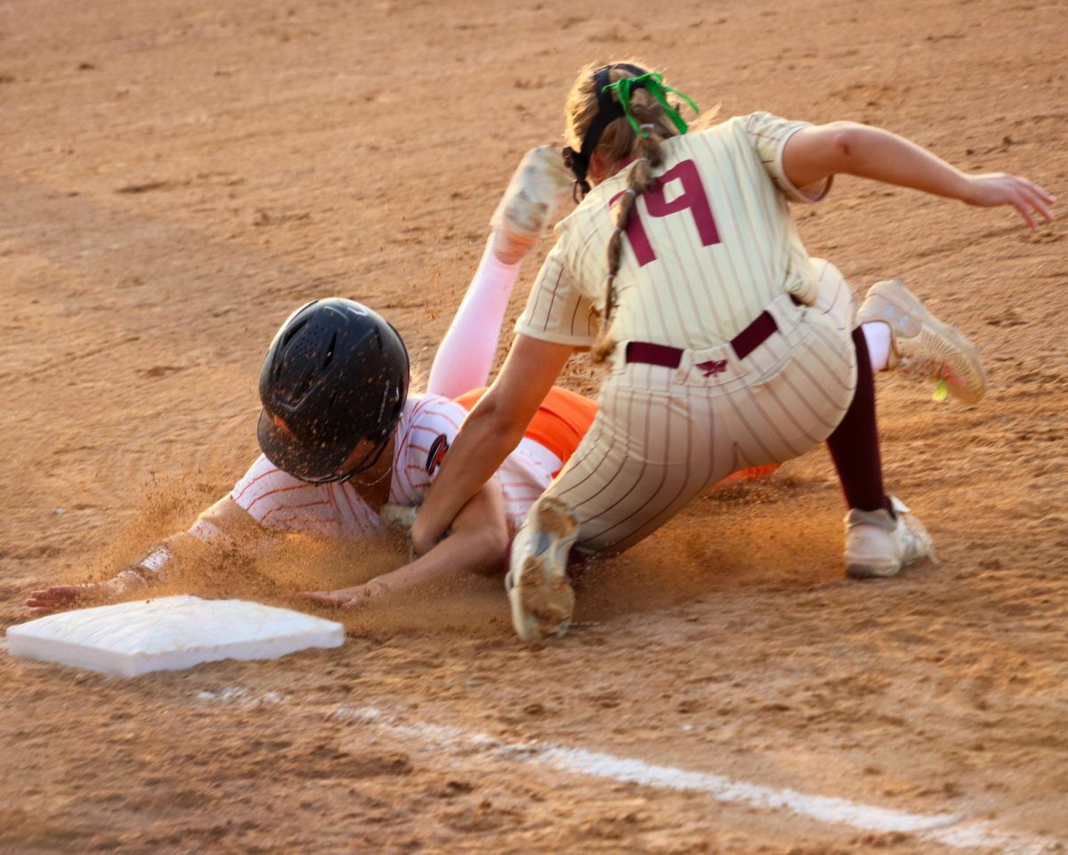 An Ames baserunner is tagged out by Kaylyn Miller (19) of Ankeny.