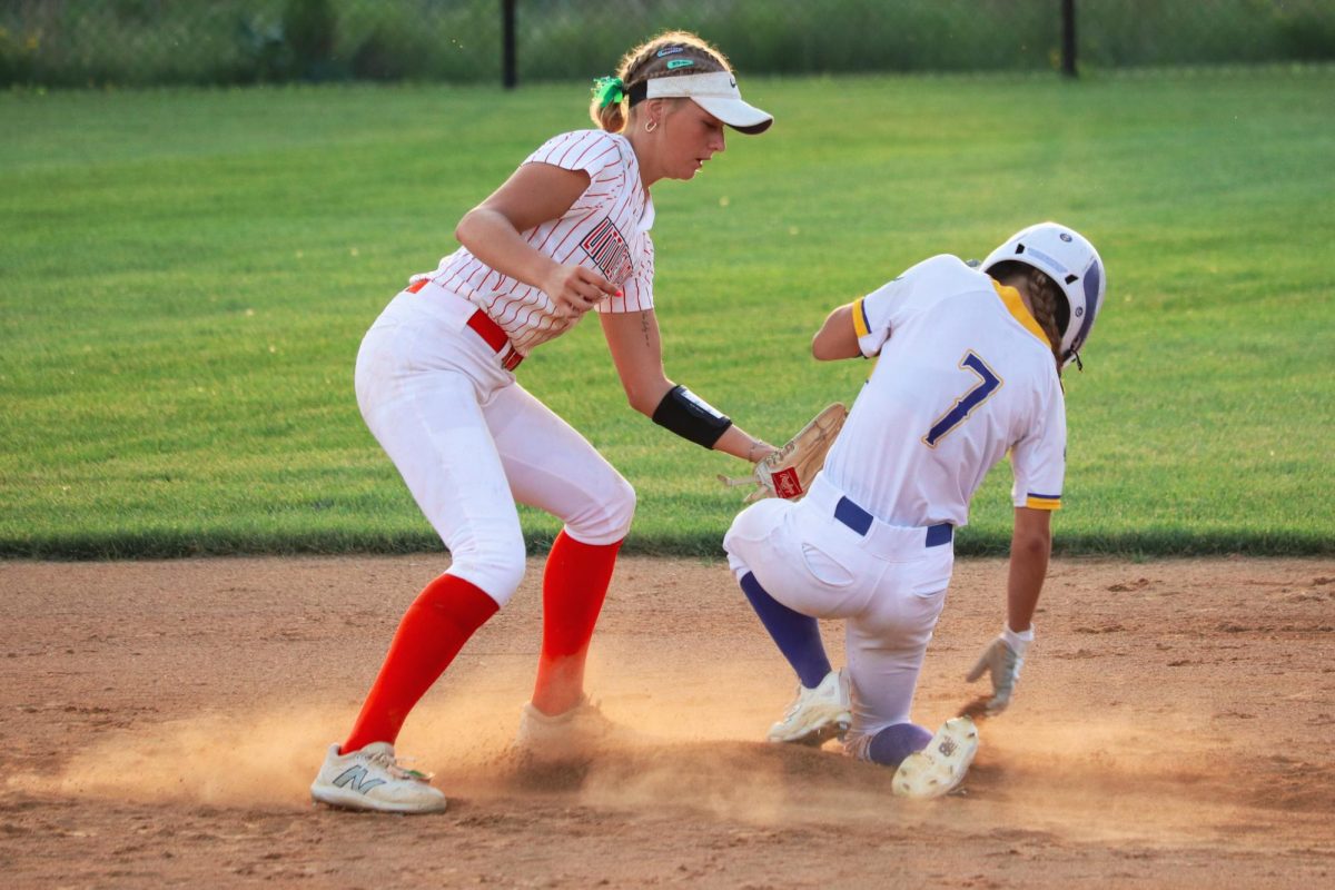 Camryn Johnson of Ames tags Kylie Sieverding (7) of Wahlert Catholic.