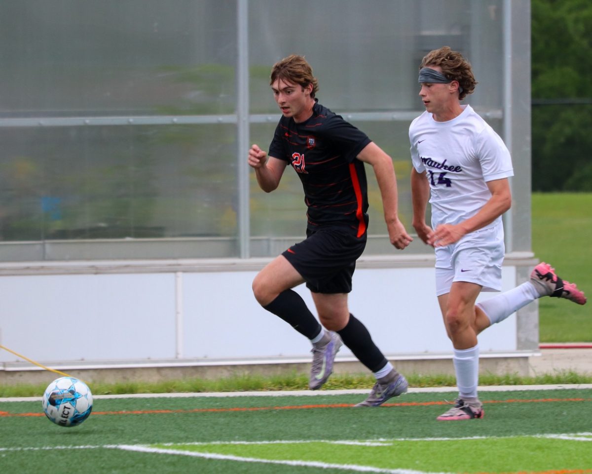 Corwyn Evans (21) of Ames dribbles past Wyatt Purvis (14) of Waukee.
