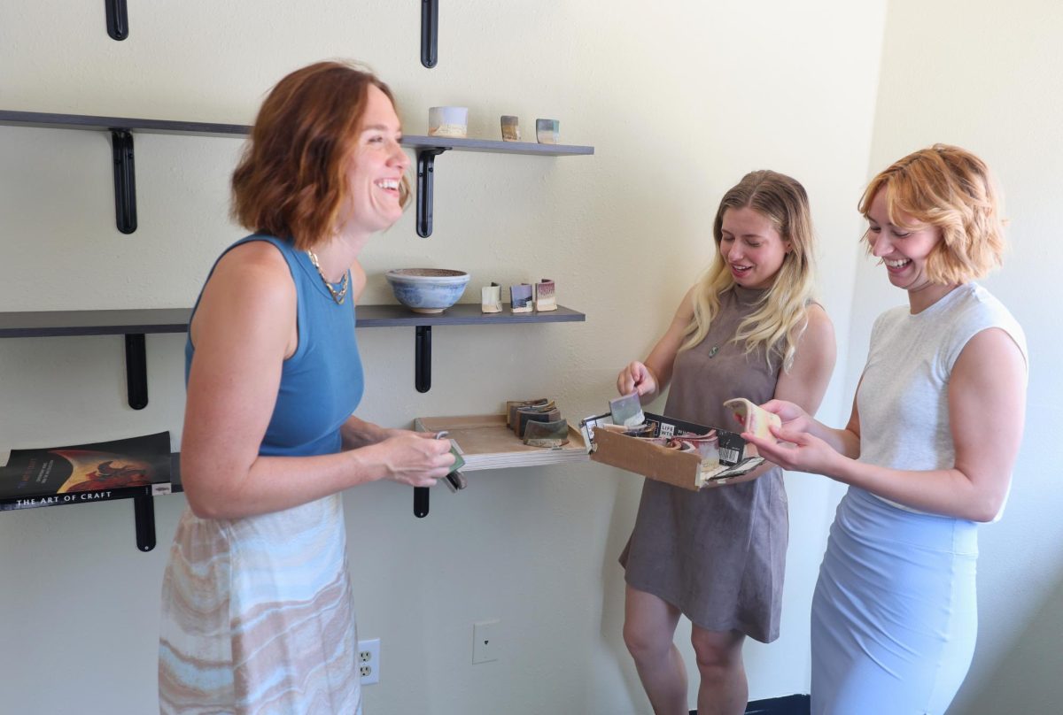 Sam Morrow, center, talks with customer at Clay-Mations Studio. An artist and teacher, Morrow recently opened the studio. (Provided by Sam Morrow)