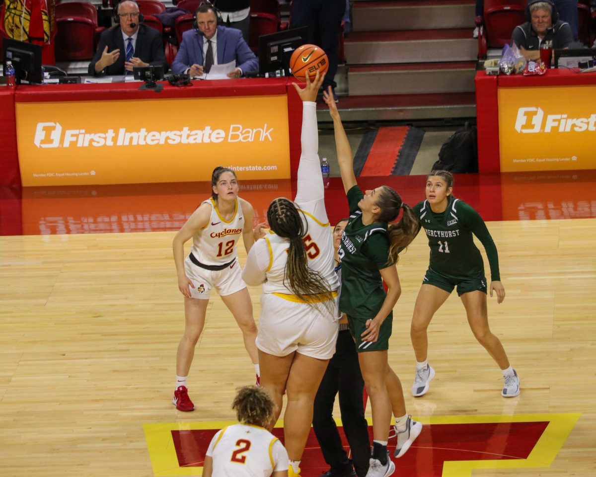Audi Crooks (55) of Iowa State wins the tipoff.
