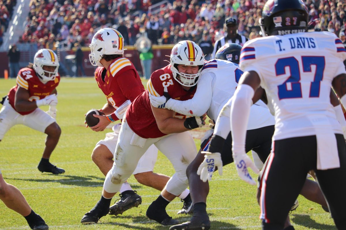 Jim Bonifas (63) paves the way for Abu Sama III (24). The Cyclones rushed the ball 50 times for 221 yards.