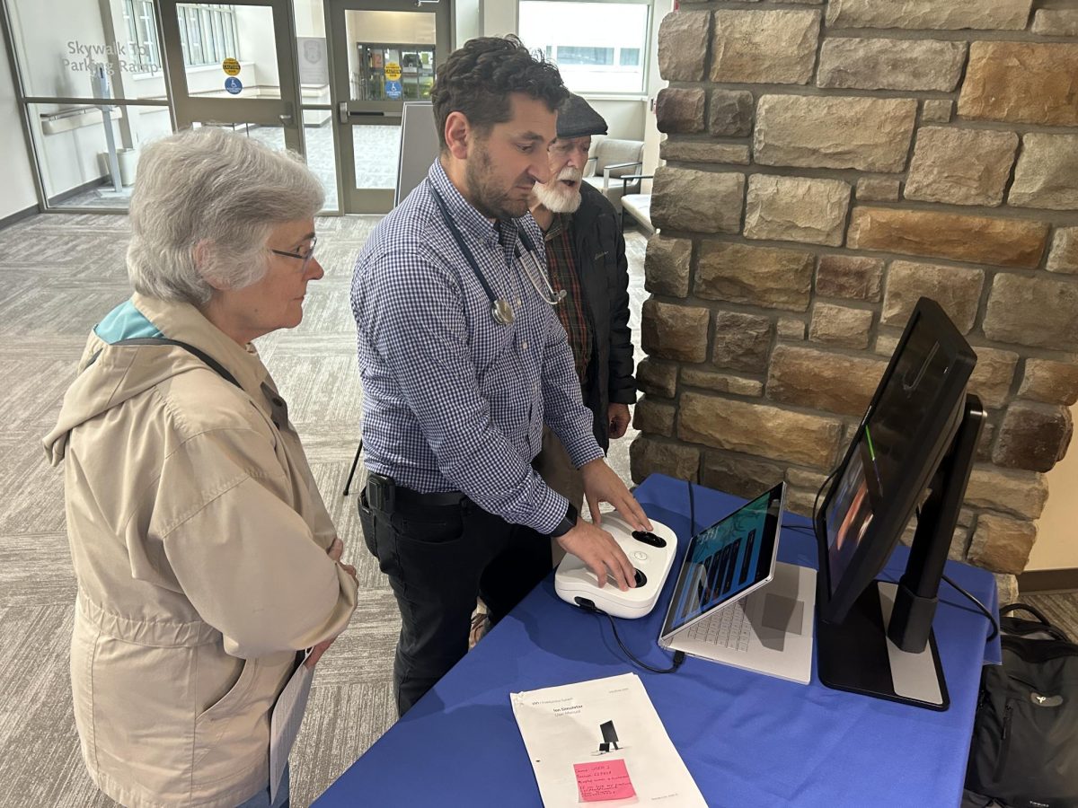 Dr. Tamim Mahayni, a McFarland Clinic pulmonologist, demonstrates the technology of the navigational bronchoscopy to a local couple during its public demonstration in November.