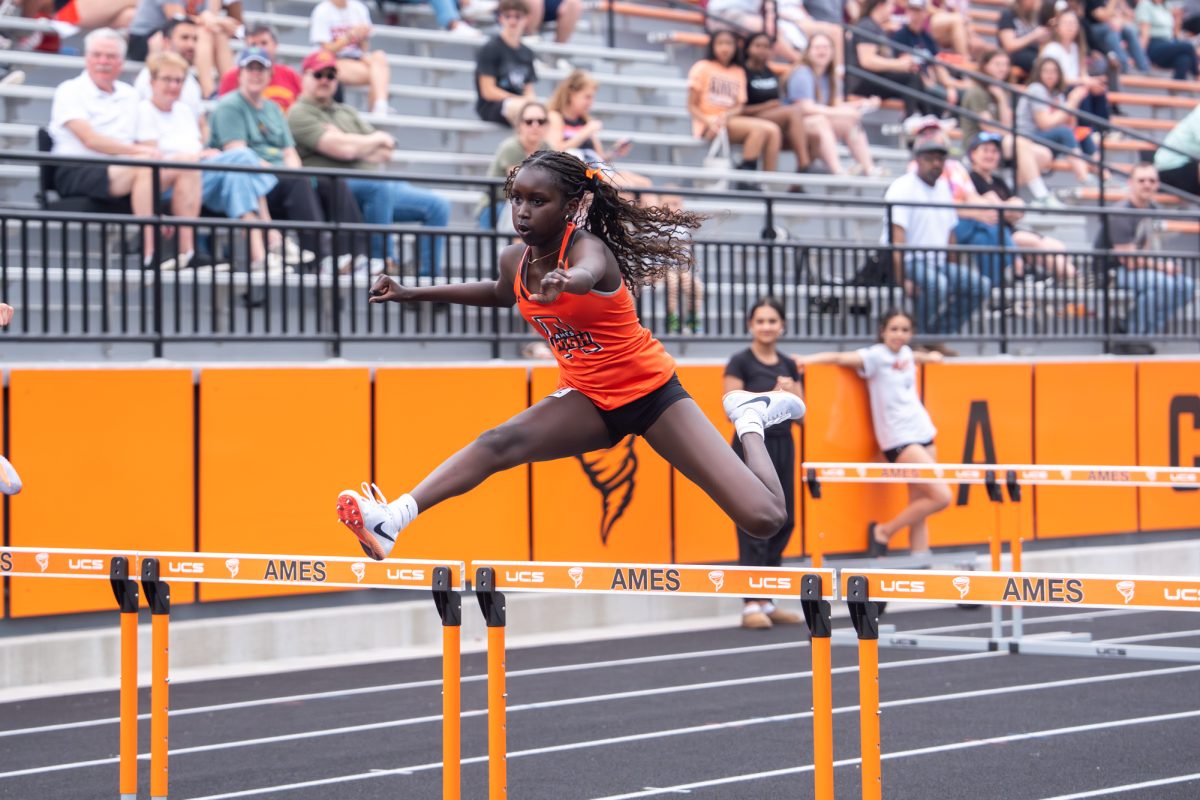 Aluel Ater of Ames High School competes in the 100-meter hurdles during the Ames Expo meet on Monday in Ames.