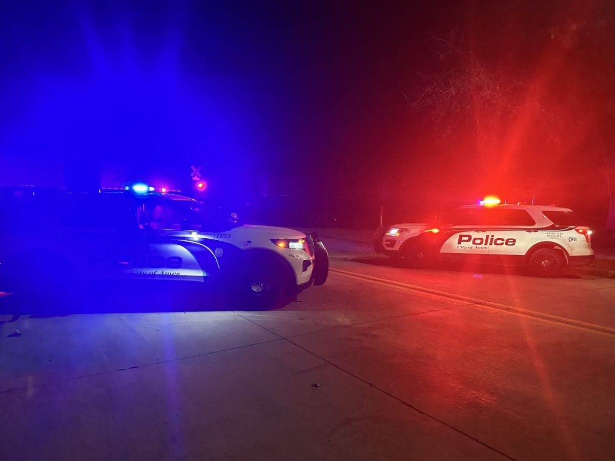 Ames Police Department vehicles respond with emergency lights activated.