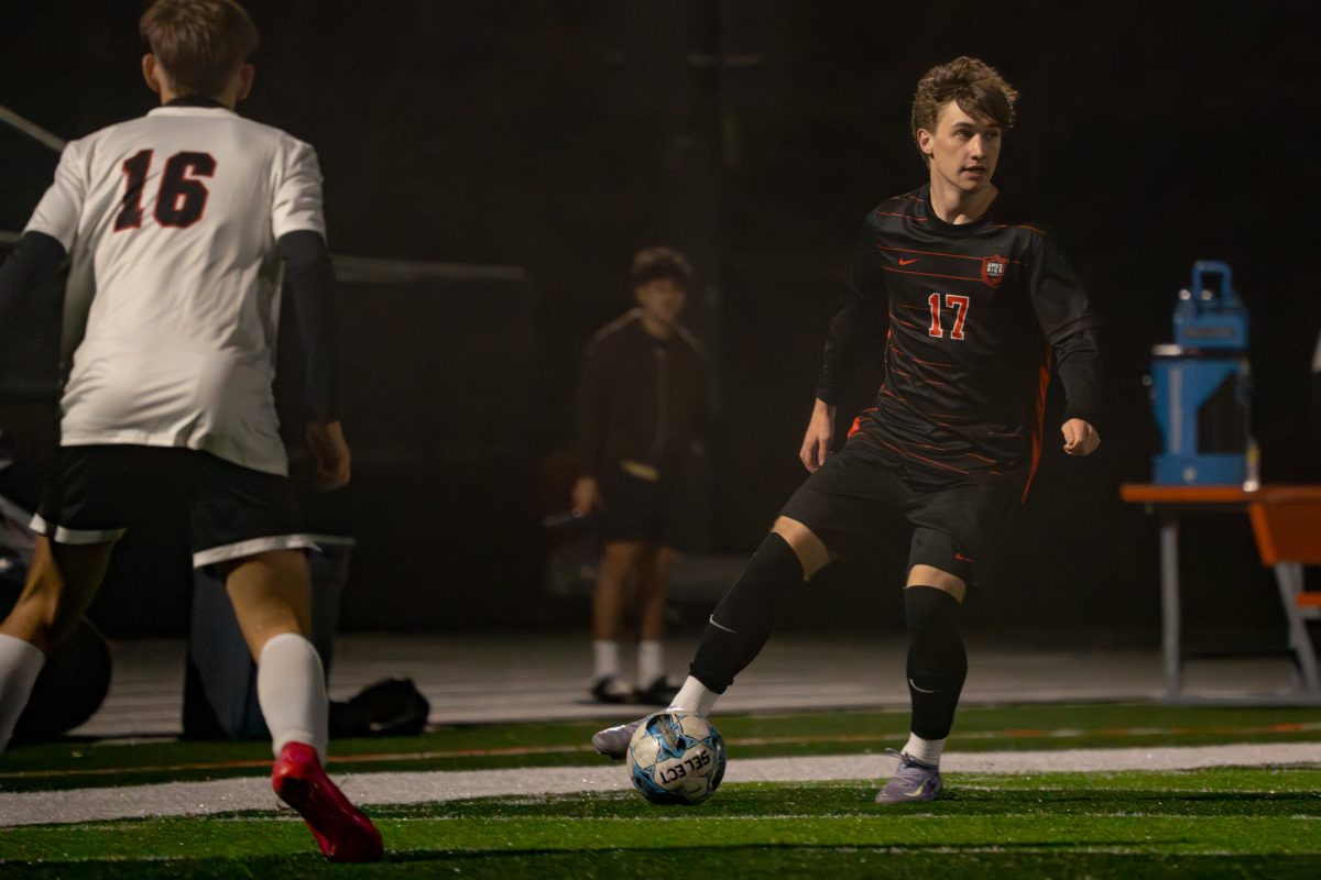 Ames High School’s Owen Meier (17) attacks Fort Dodge’s defense on Friday.
