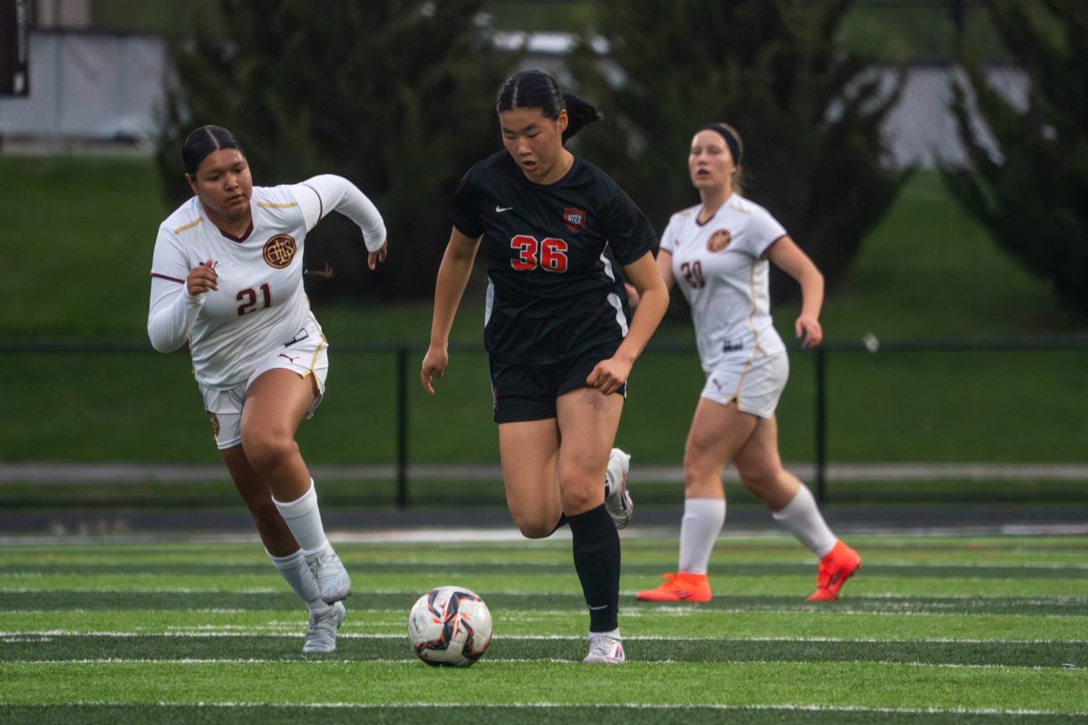 Ames High player Annie Yeh (36) dribbles down the field, pushing the defense forward to attack Des Moines Lincoln during the game on Tuesday.