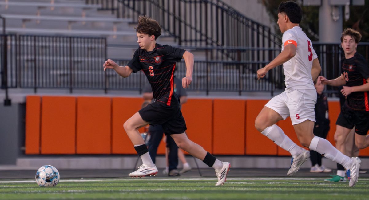 Ames’ Gavin Murphy (6) dribbles the ball downfield against Marshalltown on Thursday at Ames High School.