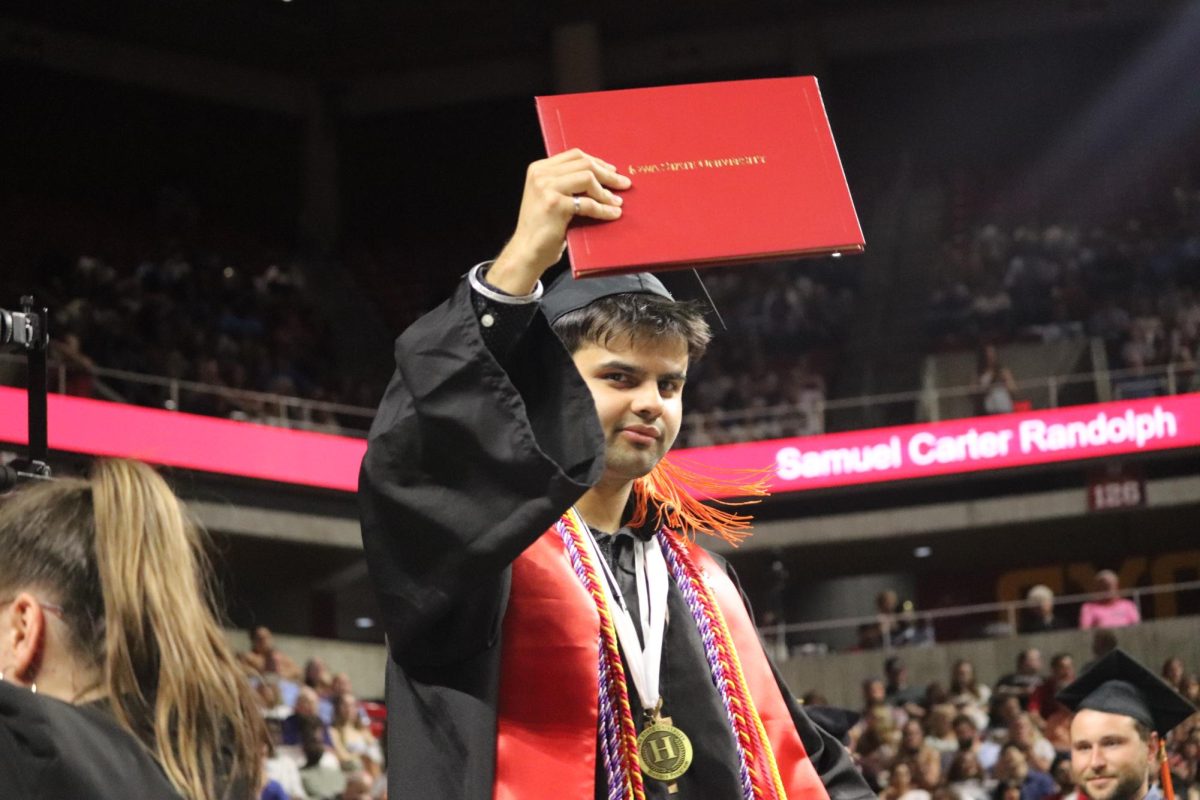 Suryansh Mishra of Chesterfield, Mo., holds up his diploma cover for his bachelor’s degree in environmental engineering. Mishra was a member of Iowa State's honors program and graduated Summa Cum Laude.