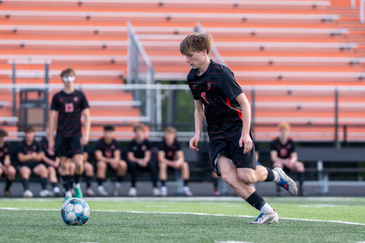 Ames athlete Jamison Lynch (8) dribbles the ball down the field during the Little Cyclones’ game against Waterloo East Trojans on Friday at Ames High School.