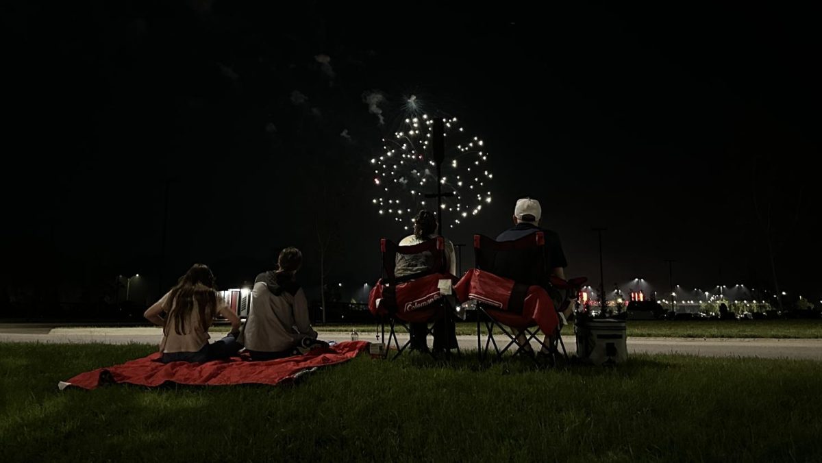 A family enjoys the Ames Fourth of July fireworks display at Jack Trice Stadium. 