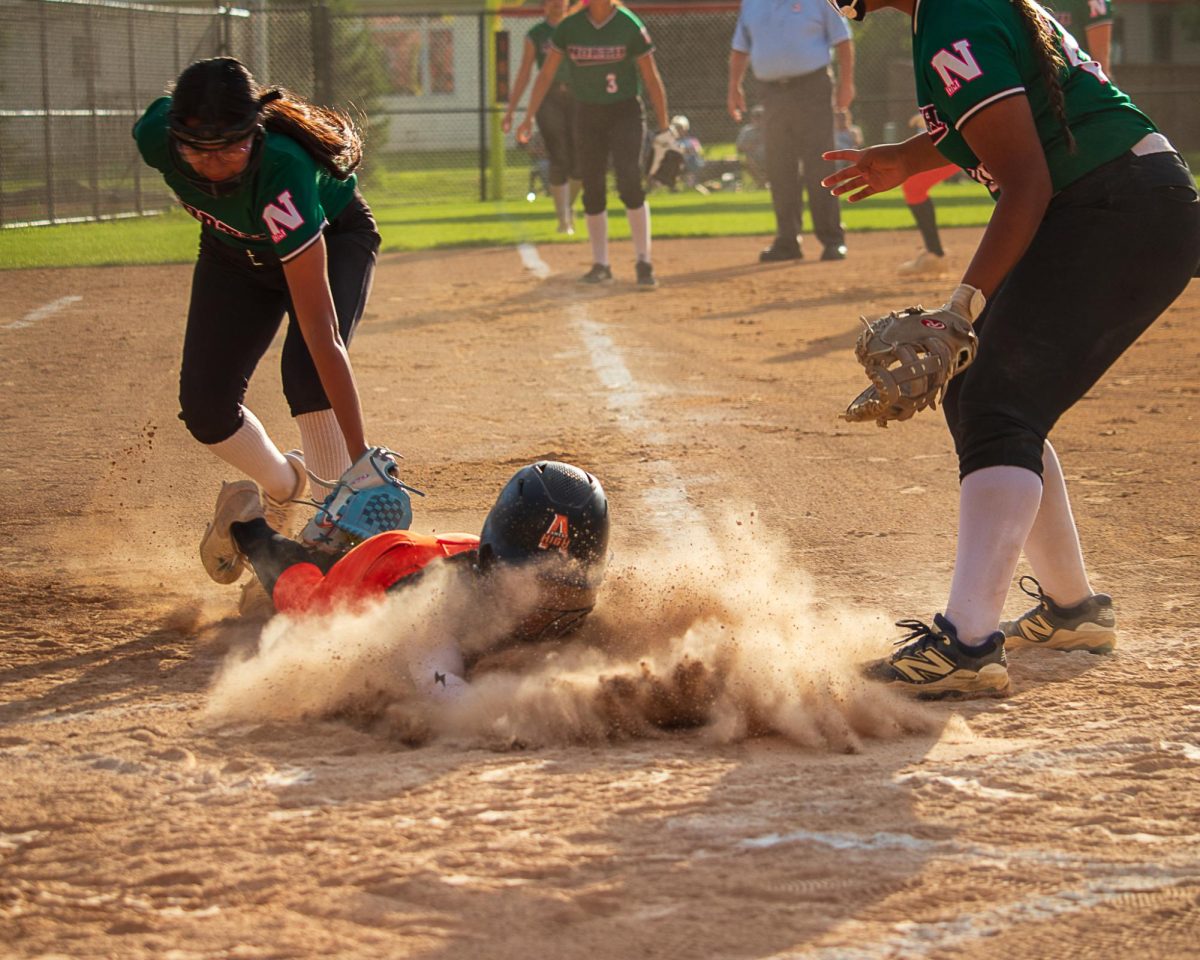 Dusty conditions were present during every slide by the Little Cyclones. In this attempt, the base runner is out.