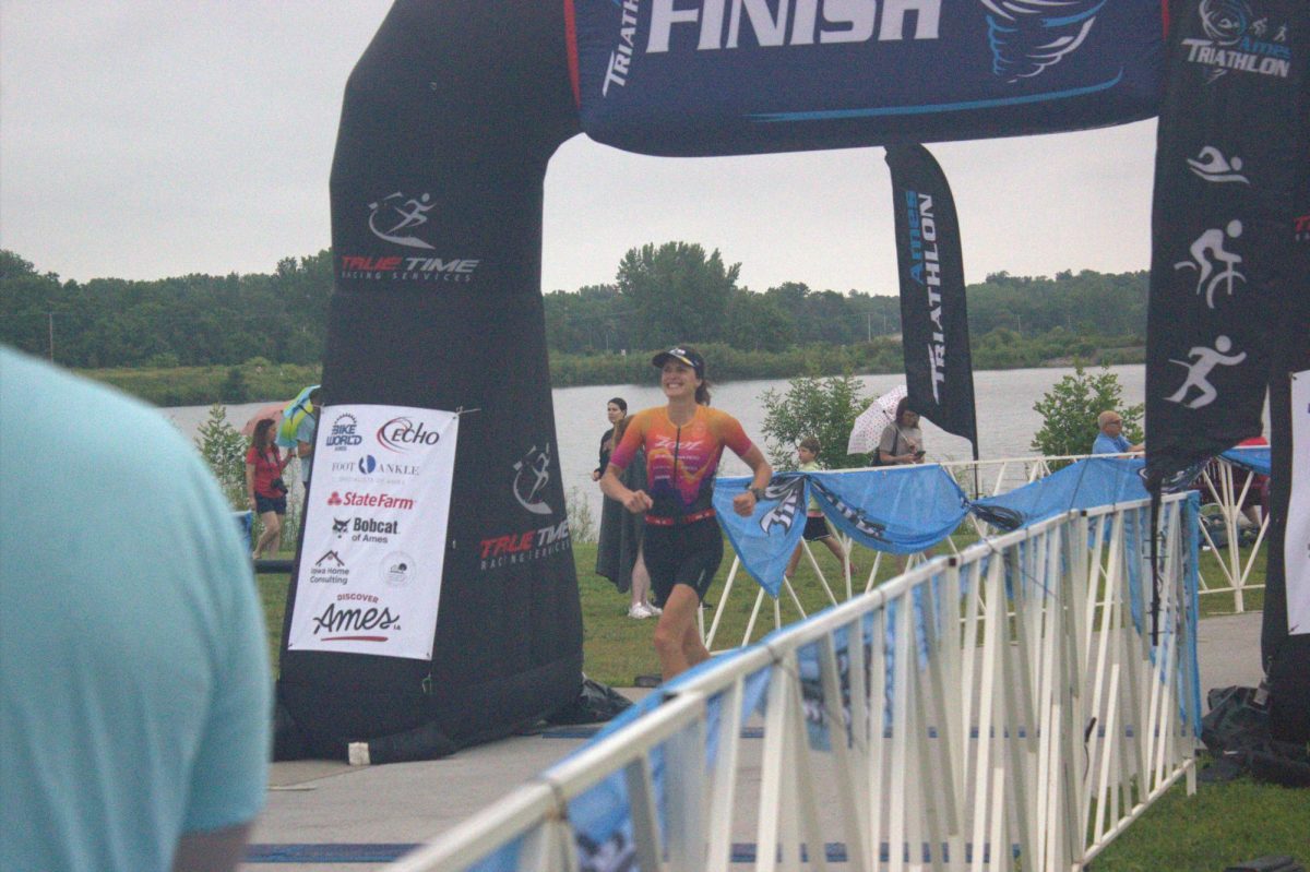 Athlete Carrie Van Quathem crosses the finish line. She earned third with a time of 1:24:26.