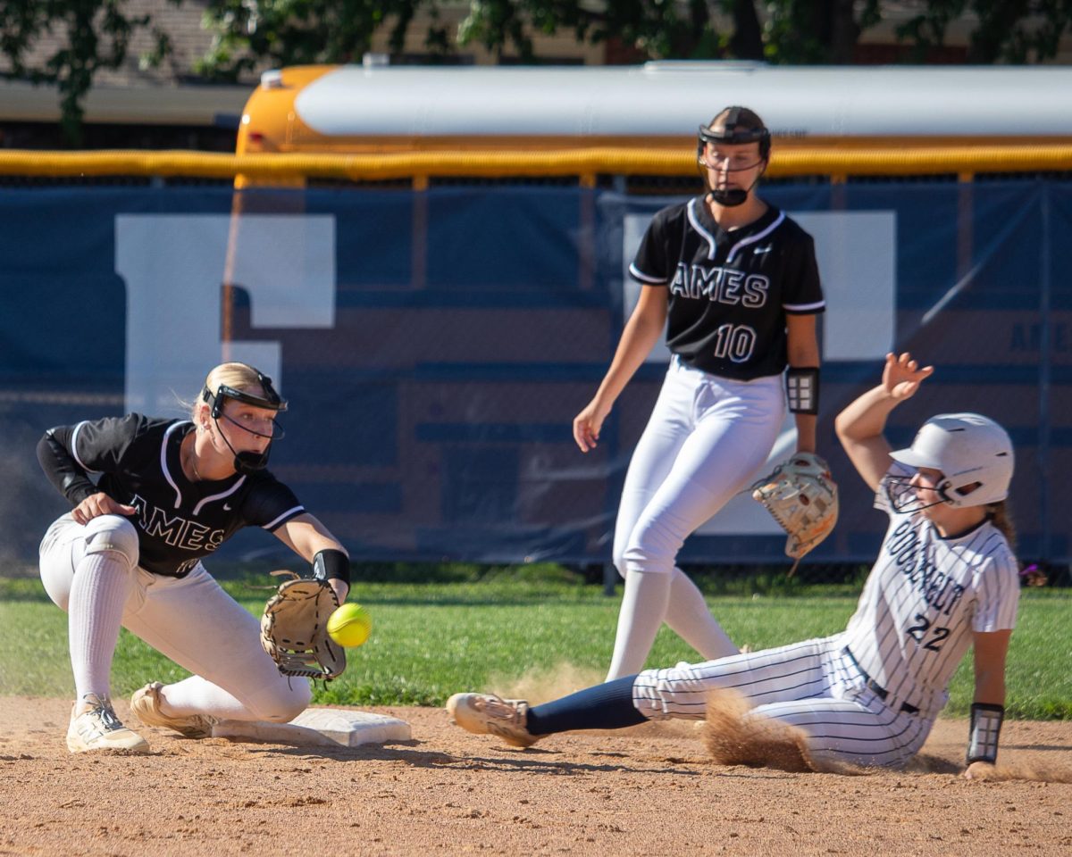 Mya Geffre (11) of Ames fields a ball while Grace Bell (22) of Des Moines Roosevelt slides toward second base.